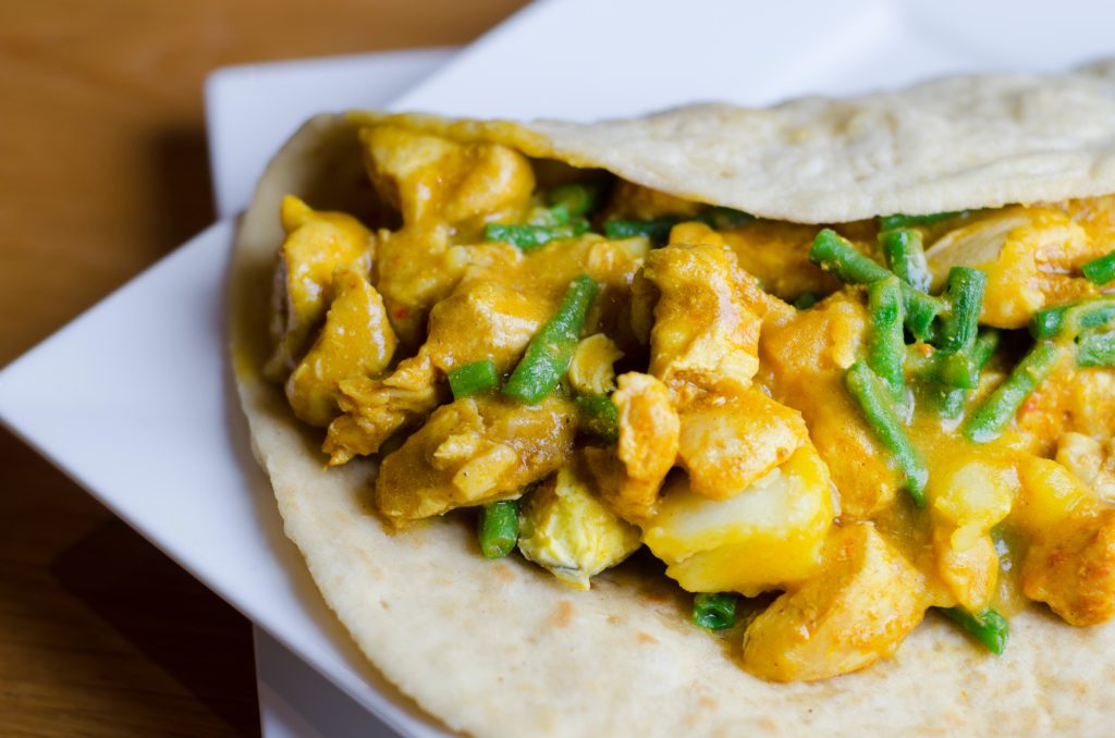 Traditional suriname chicken curry wit fresh roti